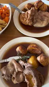 Here are a few options for your alt text, depending on what is most visible in your photo:

**Option 1 (Focus on the food - best for SEO):**
"A delicious home-cooked Sunday roast with lamb, pork, and beef served at The Farmer's Home pub in Durley, Hampshire."

**Option 2 (Focus on the experience):**
"A packed dining area and a hearty traditional roast dinner at The Farmer's Home, a charming country pub in Durley."

**Option 3 (Focus on the pub setting):**
"A variety of roast meats and seasonal vegetables served at The Farmer's Home, a family-friendly country pub in Durley."

**SEO Tip:** Since you have a local business (The Farmer's Home) and a location (Durley/Hampshire), including those in your alt text is great for local search visibility!