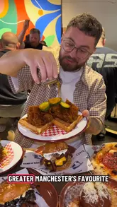 A creator visits Hatters Food Hall in Denton, showcasing dishes from four different food vendors, including fried chicken and waffles, Neapolitan pizza, arancini, paella, and burgers.