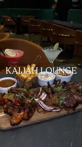 A creator visits Kaijah Lounge in Manchester, providing a review of the Afro-Southern menu, specifically highlighting the mixed grill platter, and showcasing the venue's interior decor.