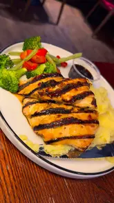 A promotional video showcasing the 'Everyday Trio' meal deal at TGI Fridays, featuring a walk-through of the venue, a look at the menu, and close-ups of various dishes including corn ribs, a chicken fajita wrap, and steak.