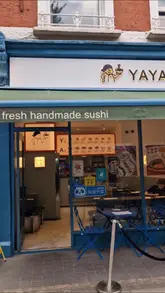 A straightforward showcase of Yaya, a casual restaurant serving a mix of Chinese and Japanese dishes. The video features shots of the exterior, the menu board, and close-ups of various dishes including bao, dumplings, sushi, and noodles.