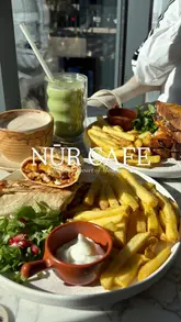 A short, music-led montage showcasing a visit to Nur Cafe in Manchester. The video features shots of the cafe's interior, a creator enjoying a coffee, and close-ups of various menu items including a chicken shawarma wrap, patty melt, fries, and cheesecakes.