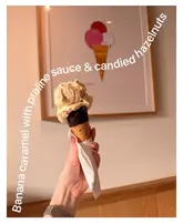A casual, handheld close-up shot of a banana caramel gelato cone, featuring text overlay describing the flavour profile.