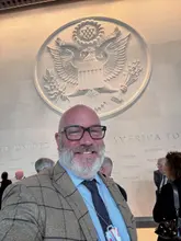 A selfie of a creator attending an event at the United States Embassy in London, highlighting a trade partnership and the promotion of U.S. beef and BBQ culture.