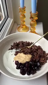 A short, instructional video demonstrating how to make 'scrambled chocolate oats' at home, featuring the mixing, cooking, and plating process.