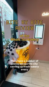 A creator visits The Whale Tea Bakery to review a selection of their fresh pastries and boba tea. The video features close-up shots of various buns and croissants, including a chicken sandwich roll, pistachio croissant, chocolate hazelnut croissant, matcha bun, and mango bun, while the creator provides commentary on the taste and texture.