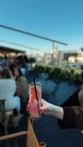 A promotional reel showcasing the reopening of a rooftop bar and restaurant, featuring small plates, cocktails, a DJ, and a lively atmosphere.