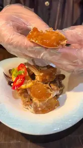A short, engaging video review of Ma Eum, a Korean restaurant in London. The creator showcases specific dishes including raw marinated crab, spicy marinated prawns, Korean fried chicken, and budae jjigae (army stew), providing a quick overview of the dining experience.