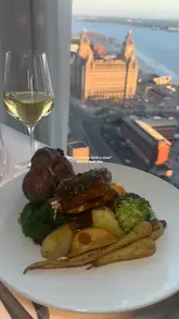 A polished montage showcasing the dining experience at Panoramic 34 in Liverpool, highlighting the panoramic city views, refined Italian-inspired dishes, and cocktail service during sunset.