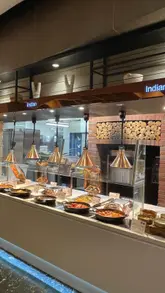 A montage of various dishes at an all-you-can-eat buffet restaurant, featuring sushi, teppanyaki, ribs, and desserts.