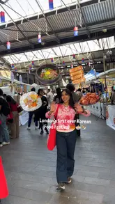 A vibrant vlog-style reel capturing the atmosphere and food offerings at London's first Korean Food Festival. The creator walks through the market, highlighting various sweet and savoury Korean dishes, including hotteok, dumplings, and unique pastries, while sharing her reactions.