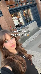 The creator visits The Spread Eagle in Homerton, London, highlighting that it is the city's only fully vegan pub. The video features a tour of the interior, including the pool area, and showcases a variety of dishes such as lion's mane mushroom steak, tempeh croquettes, and mini Korean sliders, alongside a cocktail.