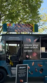 A promotional video for the KIND snack bar pop-up truck in London, showing the customization process, the 'wall of kindness,' and the prize draw.