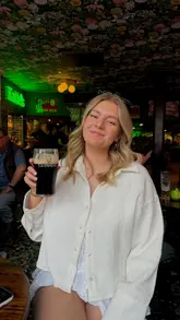 A short, handheld video tour of Katie O'Brien's Irish Tavern in Manchester, showcasing the interior, the lively atmosphere, a pint of Guinness, and a paddle of shots.