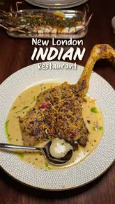 A review of Oudh 1722, a new Indian restaurant in London by chef Aktar Islam, showcasing the venue's interior and various dishes including kebabs, chicken, and cocktails.