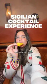 The video features a creator visiting Norma London to participate in a Sicilian-inspired cocktail masterclass. It highlights the preparation of three cocktails (Blood Orange Negroni, Italian 75, and an Espresso Martini) paired with small plates like pasta fritta and a cannoli dessert. The video also integrates a promotion for the OpenTable rewards program, showing how users can earn points by booking through the app.