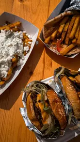 A fast-paced montage showcasing various food vendors at the Halfway Street Food Festival in Llanelli, featuring loaded fries, gyros, tater tots, tacos, pizza, hot dogs, coffee, and desserts.