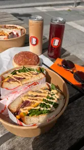 A review of a new sandwich shop called Breadwin in Newcastle, featuring a tour of the venue, a look at the menu, and a taste test of their signature sandwiches, cereal milk latte, and cereal-filled doughnut.