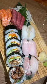 A review of Sasa Sushi in London, featuring close-ups of various sushi dishes including sashimi, tuna rolls, and spider rolls, alongside wine pairing. The creator provides a positive review of the food quality and presentation.