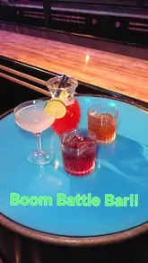 A couple visits Boom Battle Bar to try their new activity bundle, featuring shuffleboard, cocktails, and a variety of street food plates.
