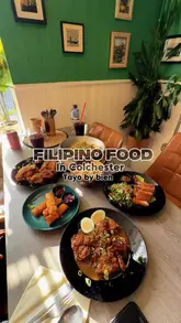 A food review reel showcasing various Filipino dishes at a restaurant in Colchester, including lechon, pancit, fried chicken, garlic fried rice, lumpia, and bbq pork skewers.
