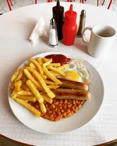 Forty years of graft, brews and proper breakfasts at The Forum Cafe in Earlestown and then just like that, it’s gone.

Last week I was gutted to find out that there was a note on the door saying “retirement, closed,” with no big farewell, no rebrand, no “under new management,” just a quiet, matter of fact ending that somehow says everything about the place and the people who ran it.

The red and white tiles, the metal chairs, the radio humming away in the background, and that smell of chip fat that hit you before you’d even sat down. The toast buttered properly like being back at school, cheap sausages and conversations that felt like they belonged to the room rather than to any one person.

A lovely Husband and Wife ownership. It wasn’t perfect and that’s exactly why it mattered because perfection was never the point. They gave the town forty years of consistency, of familiar faces and steady rhythm, a proper community hub long before anyone started dressing places up and calling them that. Generations of local families graced its tables.  And now as the market around it gets “regenerated” with artisan this and craft that, places like this sadly slip away without much noise.

But fair play to them. They never buckled to pressure or trends. No flat whites, no sourdough, no pretending to be something it wasn’t, just real people, real food, and real life carrying on as it always had. 

Funnily enough the’d just hit a national audience for the first time as the cafe featured in the new BBC drama The Cage with the talented @sheridansmithster and @michaelsocha13. A top gritty series written by local legend @tonyshoey 

Maybe someone will take it on and keep it going and you’d like to think they might, but even if they do, you can’t help wondering whether it would ever really feel the same again or whether what made it special has already had its time.

End of an era, truly. ❤️

#fullenglish #cafe #britishculture #wellgoodblog