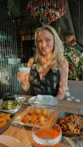 A couple enjoys an evening at Clap in Knightsbridge, London. The video features a tour of the stylish, Tokyo-inspired interior, close-ups of various Japanese dishes including sushi and sashimi, and shots of cocktails and the bar area, highlighting the venue's upscale and lively atmosphere.