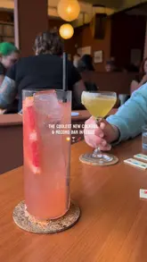 A short montage showcasing the interior, cocktails, and relaxed atmosphere of a new cocktail and record bar in Leeds, featuring patrons playing board games.