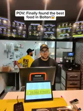 A first-person POV video review of 'Side Street' in Bolton. The creator visits the venue, orders a variety of items including a smash burger, loaded fries, and a brisket sandwich, and then reviews the food from their car.