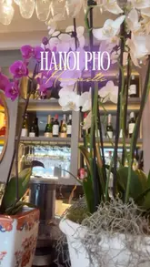 A promotional reel for Hanoi Pho in Newcastle, featuring a montage of the restaurant's interior, menu, and various Vietnamese dishes, ending with a shot of the creator and a child.