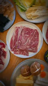 A short, aesthetic video demonstrating the preparation of a Sukiyaki meal kit at home, focusing on the quality of the Wagyu beef and the dipping process.