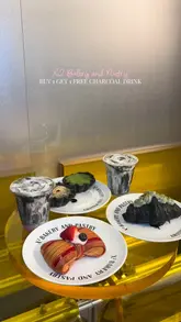 A short review video showcasing a selection of pastries and charcoal-based drinks at X2 Bakery and Pastry. The video features close-up shots of the food items on a table and a brief pan of the bakery display case, accompanied by a voiceover sharing opinions on the items.