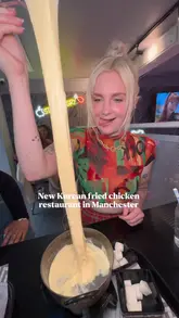 A creator visits a Korean fried chicken restaurant in Manchester, showcasing their signature cheese fondue and fried chicken platter. The video features the creator trying the food, demonstrating the cheese pull, and providing a casual review of the experience.