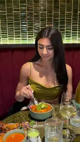 A short, polished reel showcasing a dining experience at Rawsha, featuring close-ups of various Indian dishes including lamb chops, curries, and biryani, alongside shots of the restaurant's interior and the creator enjoying the meal.