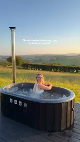 A couple showcases their stay at Crockanboy Cabins in Ireland, highlighting the scenic views, the hot tub, the cozy interior, and their relaxed evening and morning routine.