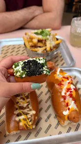 A review of 'Oh My Dog' featuring their viral cream cheese and caviar hot dog, along with other menu items like the Yum Dog, Chilli Cheese Dog, and garlic bread fries.
