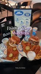 A short-form video showcasing the 'Munchbox' collaboration between Boo and Drip Chicken. The video features close-up shots of burgers, Nashville hot chicken tenders, fries, and drinks, highlighting the textures and sauces. It uses text overlays to identify the collaboration and the items included.