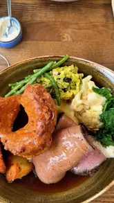 A short video showcasing a Sunday roast experience at The Tickled Trout in Derbyshire, featuring close-ups of the meal and a brief look at the restaurant interior.
