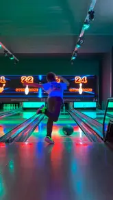 A fast-paced, energetic video showcasing a family's visit to Discobowl, highlighting the various activities available including bowling, mini-golf, karaoke, pool, and arcade games, alongside casual dining.