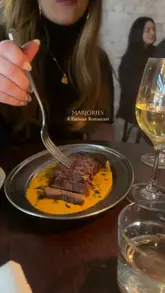 A short, aesthetic montage showcasing the interior, atmosphere, and dishes at Marjories, a Parisian-style restaurant in Soho. The video features close-ups of steak and dessert, alongside shots of wine and the candlelit dining environment.