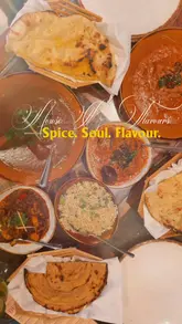 Here are a few options for your alt text, depending on what is most visible in the photo:

**Option 1 (Focus on the meal):**
"A delicious spread of authentic Indian curries and naan bread served at House of Flavours restaurant in Reading."

**Option 2 (Descriptive):**
"Close-up of a variety of flavorful Indian dishes and sides served at the House of Flavours restaurant."

**Option 3 (Action-oriented):**
"A table full of hearty, authentic Indian food and curries at House of Flavours in Reading, UK."

**SEO Tip:** I included "House of Flavours" and "Reading" as these are your most important keywords for local SEO.