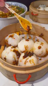 A food review video featuring a visit to Mr. Dumpling in London. The creator showcases a variety of handmade dumplings, including spicy beef, prawn, pork, and chive, as well as potstickers and hand-pulled noodle soups. The video uses close-up shots to highlight the texture and preparation of the food, accompanied by the creator's enthusiastic commentary.