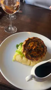 A montage of a visit to The Feathers in Holt, featuring shots of the interior, a steak and ale pie, an affogato, and wine.