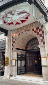 A review-style video showcasing the dining experience at a traditional London restaurant, highlighting the silver service roast beef trolley, cocktails, and dessert.