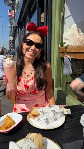 A creator visits Kulture Coffee to review their new sandwich menu and iconic volcano cookies. The video features close-ups of a pink latte, a matcha latte, a garlic chicken and bacon sandwich, a parmo sandwich, and two different cookies, interspersed with the creator's commentary.