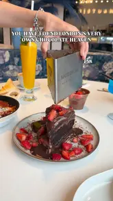 A promotional video for Haute Dolci at The O2, showcasing their dessert-heavy menu including the signature Matilda chocolate cake, San Sebastian cheesecake, and brunch items like shakshouka, set in a stylish, modern cafe environment.