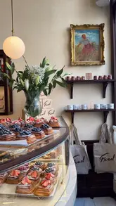 A montage-style video showcasing the interior and various pastries at Fred Bakery in London, focusing on the aesthetic presentation of the food and the cozy atmosphere.