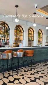 A montage video showcasing the interior, food, and drinks at Fremantle Bar & Kitchen, followed by shots of the surrounding Docklands area and cable car.