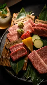 A cinematic showcase of a high-end Japanese Yakiniku restaurant in London, focusing on the preparation and grilling of premium A5 Wagyu beef. The video uses slow-motion close-ups to highlight the marbling of the meat and the precision of the cooking process, creating an atmosphere of luxury and indulgence.