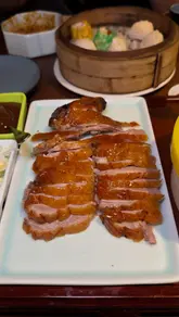 The video is a fast-paced listicle featuring three Chinese restaurants in London: Dan Dan, Bun House, and Noodle Inn. The creator visits each location, showcasing signature dishes like roast duck, hand-pulled beef short rib noodles, and steamed custard buns. The video uses a vlog-style format with quick cuts, close-ups of the food, and the creator's reactions to the meals.
